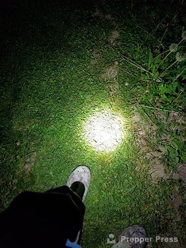 tactical flashlight on ground