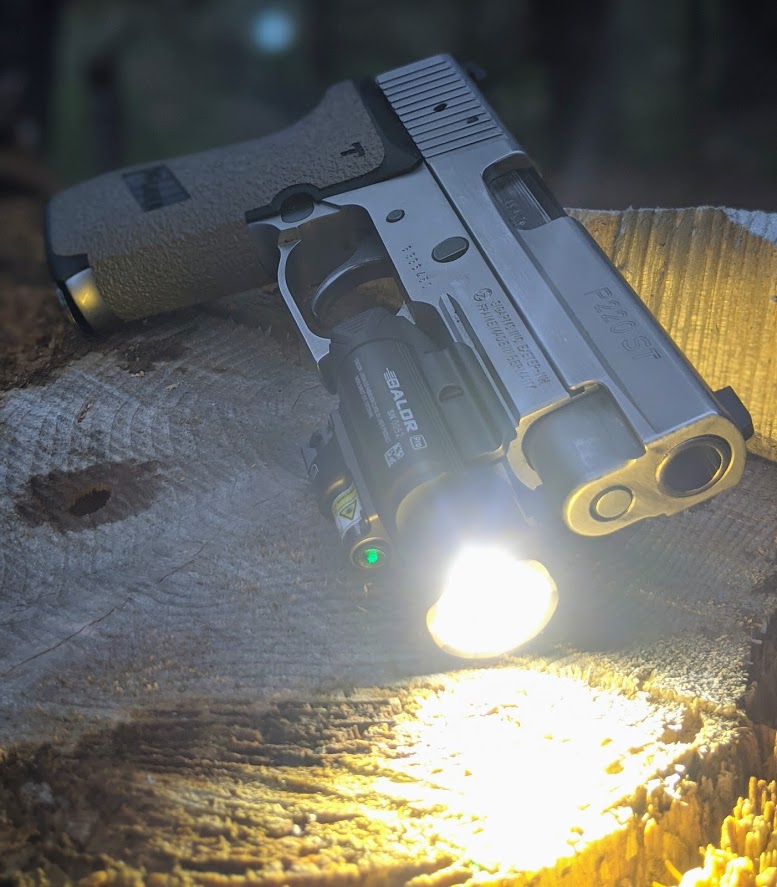 Olight Baldr Pro on a SIG Sauer P220ST at dusk