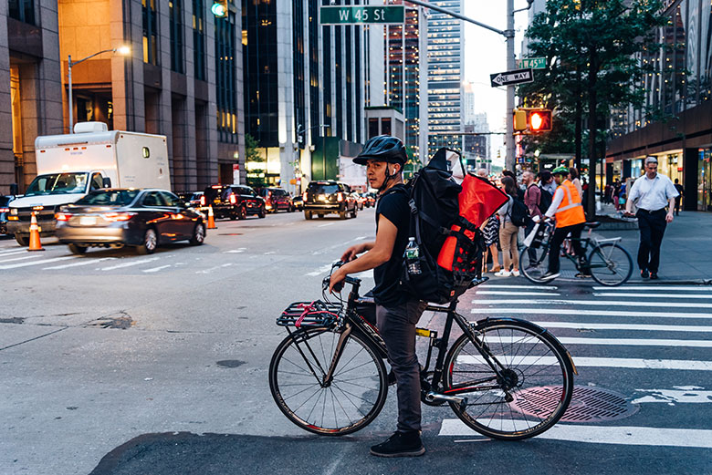 a man on a bicycle in a city