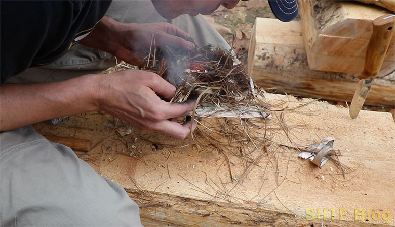 blowing a coal into a fire