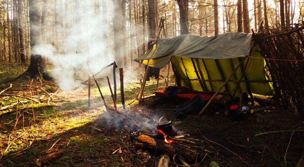 a bushcraft shelter in the woods