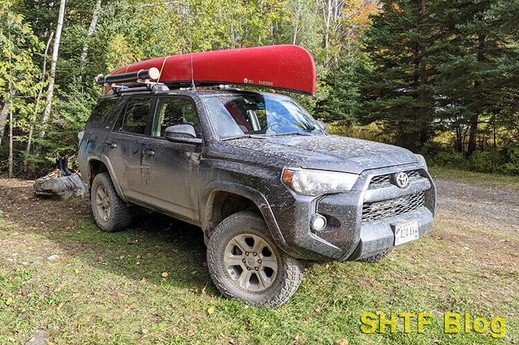 canoe tied on a car