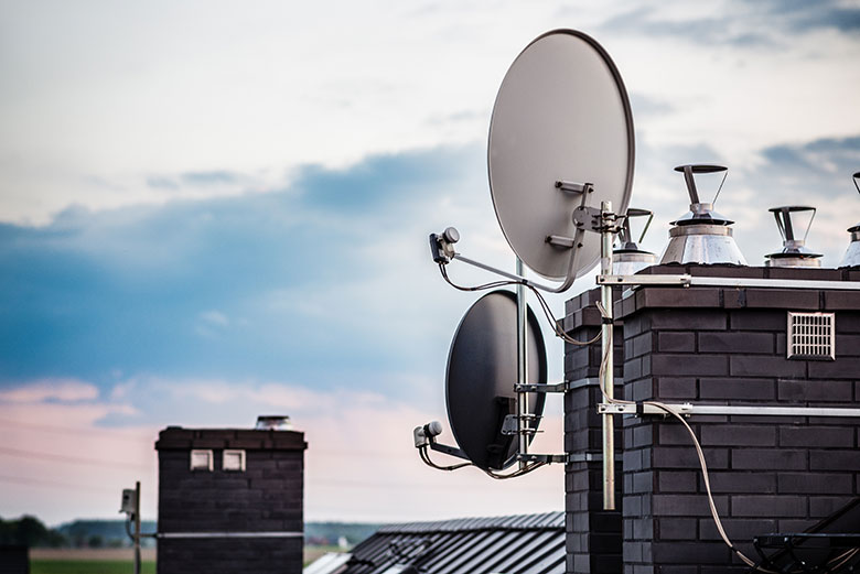 satellite dishes on a roof indicating direction