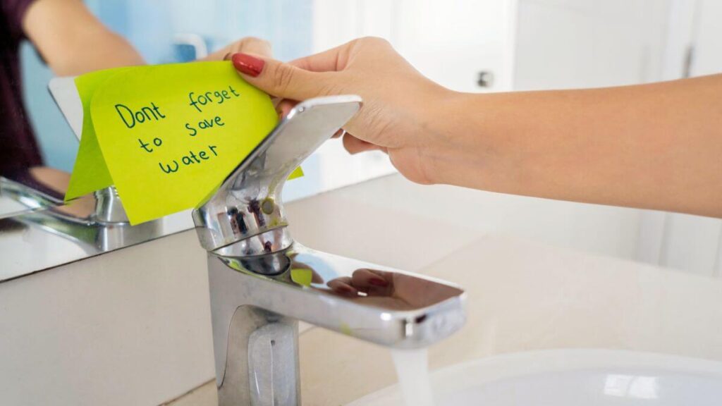 woman sticking a note near washbowl